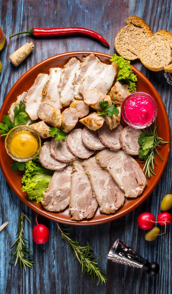 Meat platter in a plate with sauce and herbs