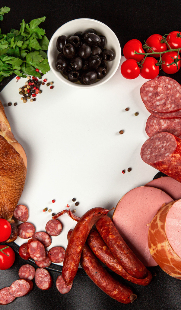 Smoked meats on the table with spices and tomatoes