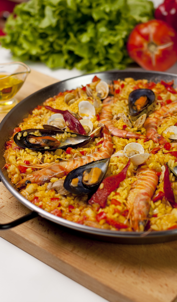 Pilaf with seafood on a table with vegetables