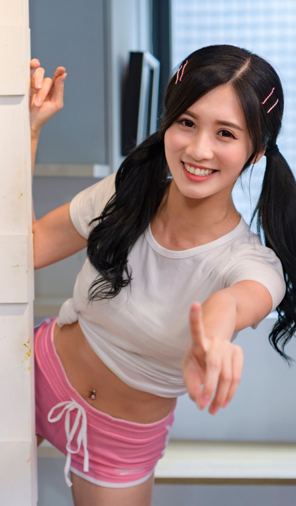 Улыбающаяся девушка азиатка в комнате