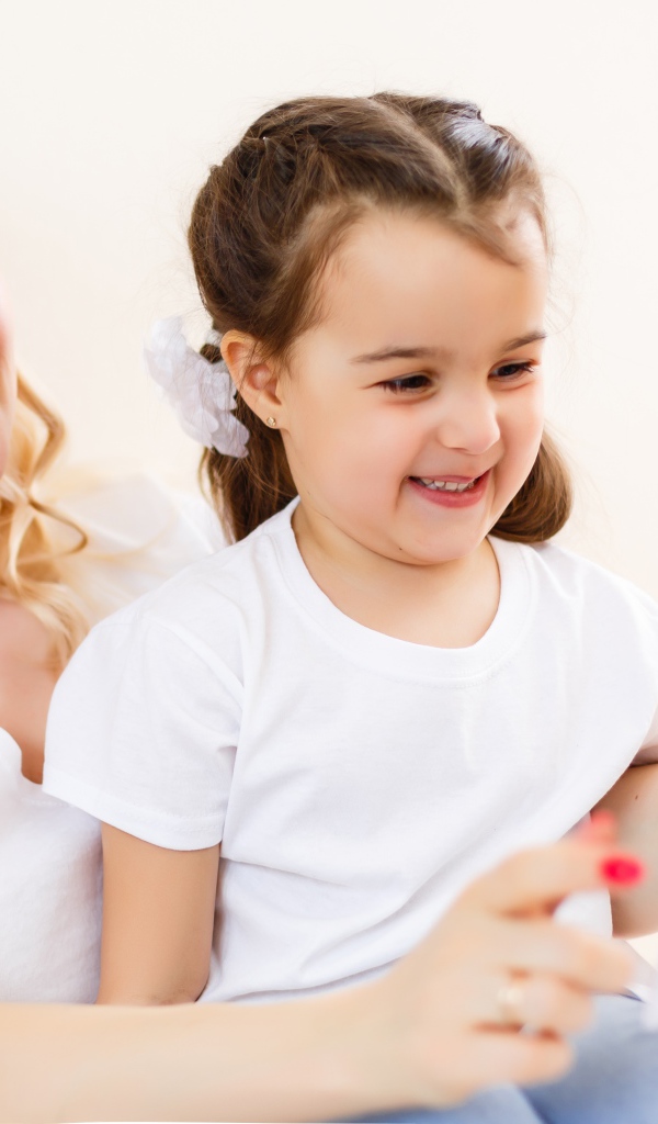 Женщина с маленькой девочкой сидят на  диване