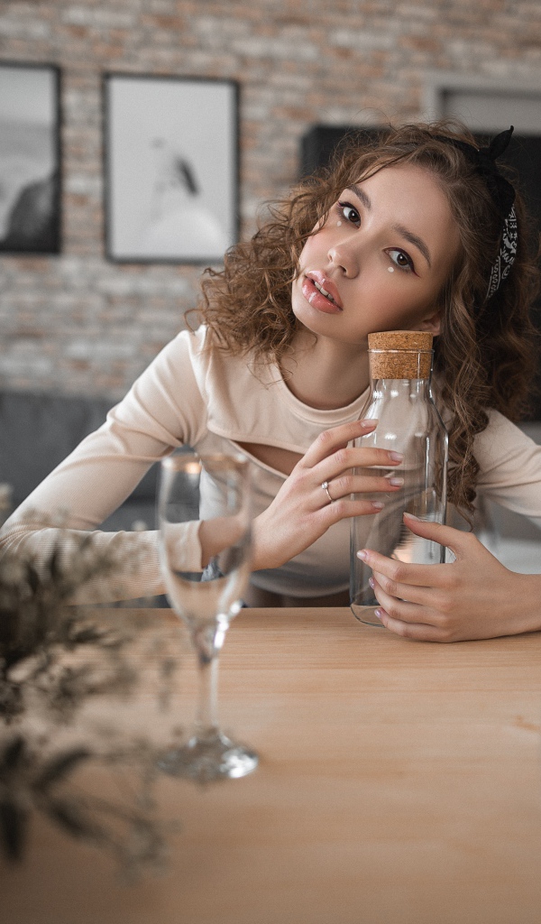 Young girl model sits in a cafe at the table