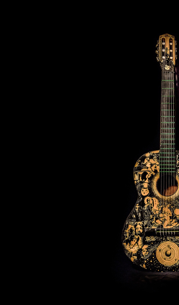 Красивая гитара с рисунком на черном фоне