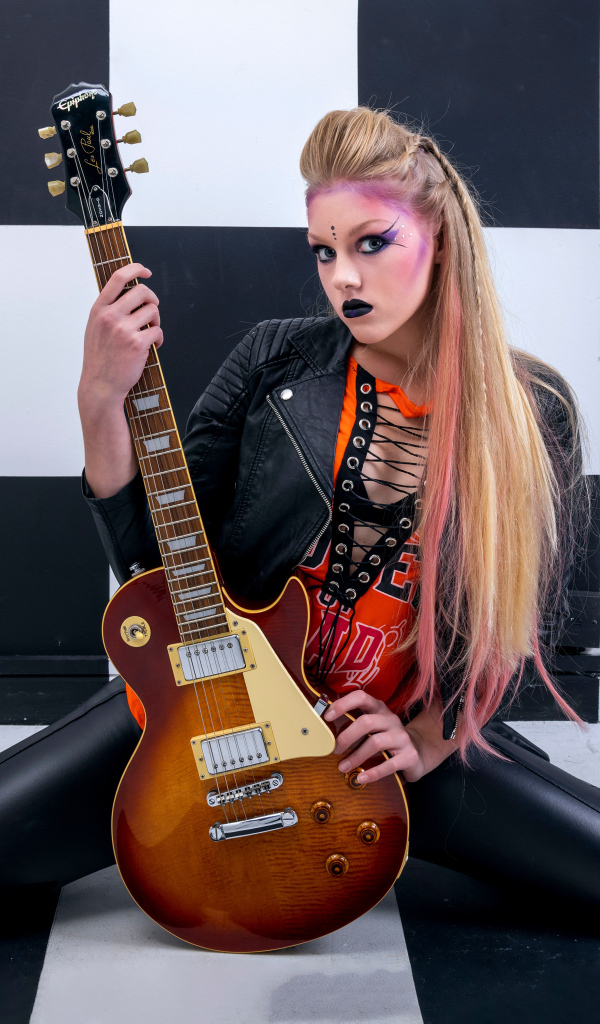 Rocker girl with a guitar in her hands