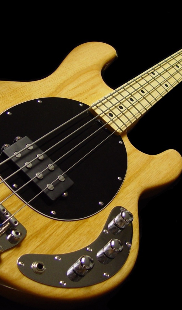 Wooden guitar with thick strings on a black background