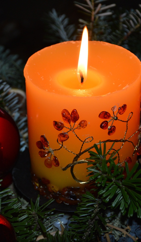 Lighted candle with fir branches