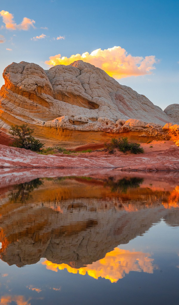 Красивая необычная гора у воды под голубым небом