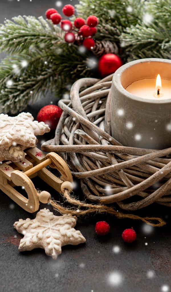 Зажженная свеча с еловой веткой и украшениями