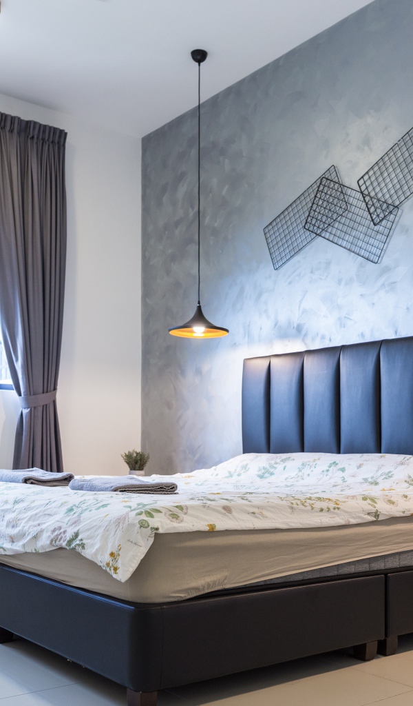 Пустая спальная комната с большой кроватью у окна 