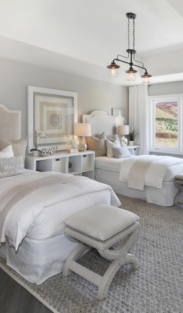 Две кровати в спальне с большим окном