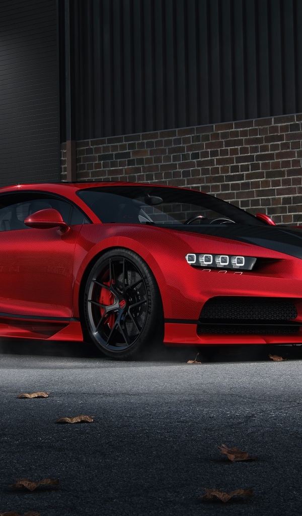 Красный автомобиль Bugatti Chiron CGI у кирпичной стены
