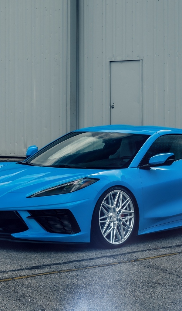 Синий Chevrolet Corvette C8 у серого здания