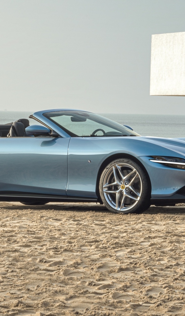 Автомобиль Ferrari Roma Spider 2023 года стоит на песке