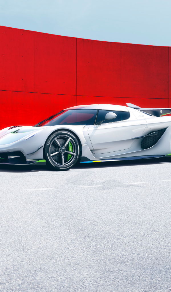 Автомобиль Koenigsegg Jesko на фоне красной стены