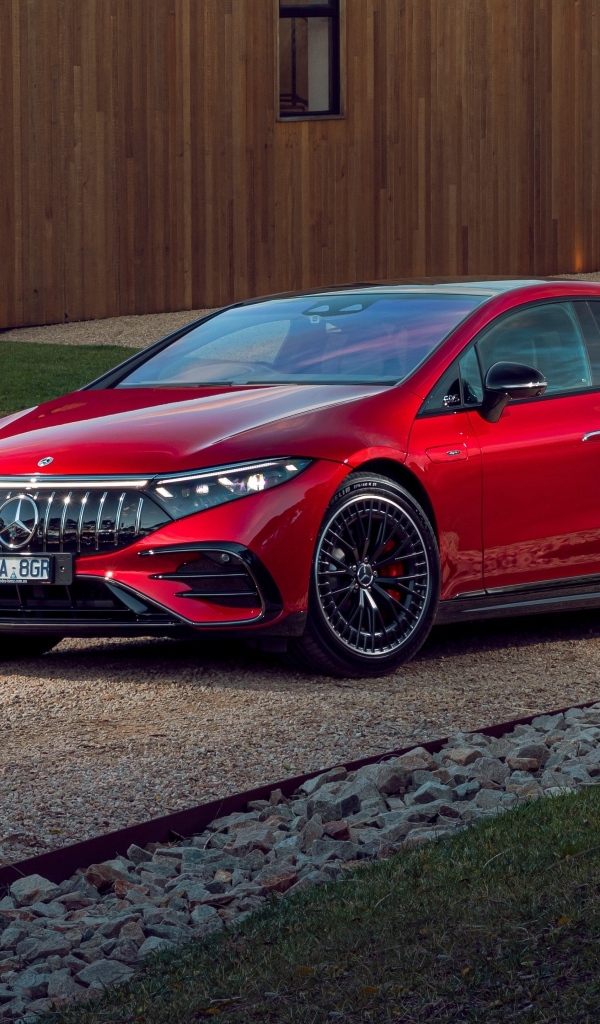 Красный автомобиль Mercedes-AMG EQS 53 4MATIC+  у дома