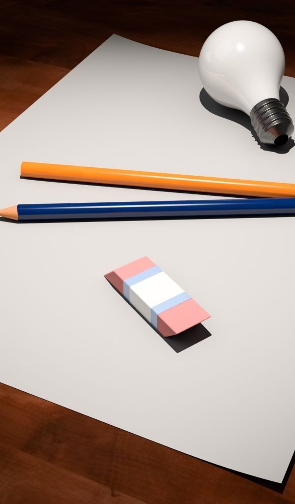 Лист бумаги, карандаши, ластик и лампочка на столе