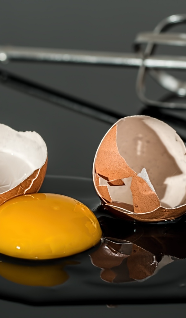 Разбитое яйцо на черном столе