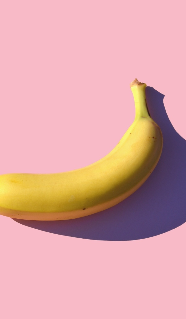 Желтый банан на розовом фоне