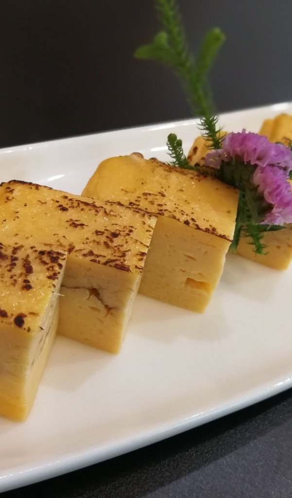 Запеканка на большой белой тарелке на столе