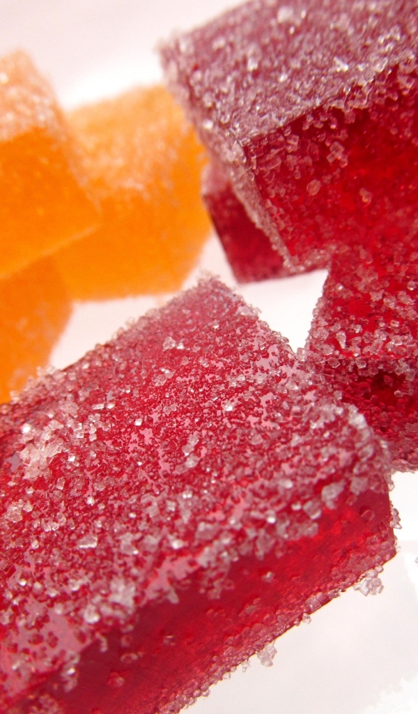 Куски сладкого ягодного мармелада на белом фоне