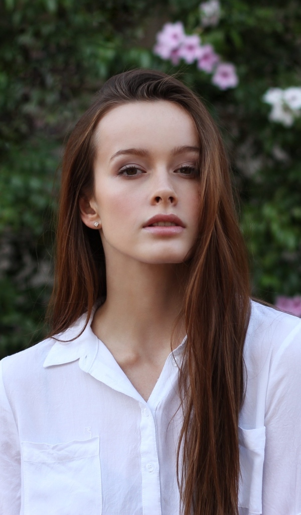 Красивая длинноволосая девушка в белой рубашке