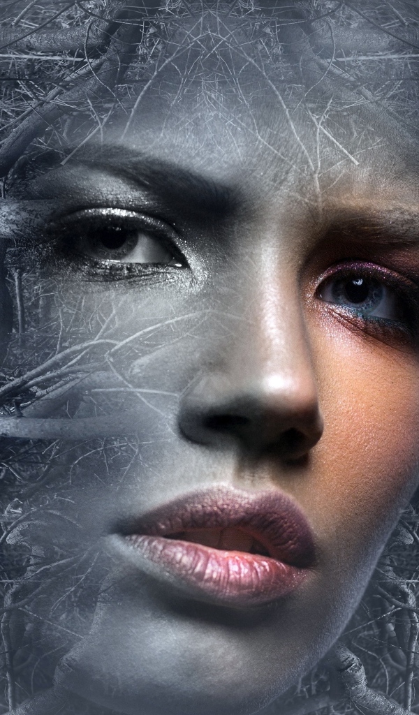 Лицо девушки в ветках дерева