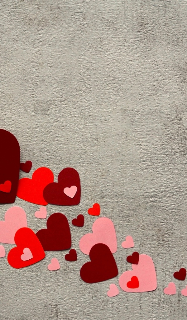 Paper hearts with a brush on a gray background
