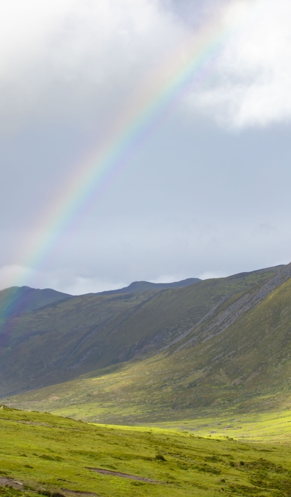 Радуга над покрытыми зеленью холмами