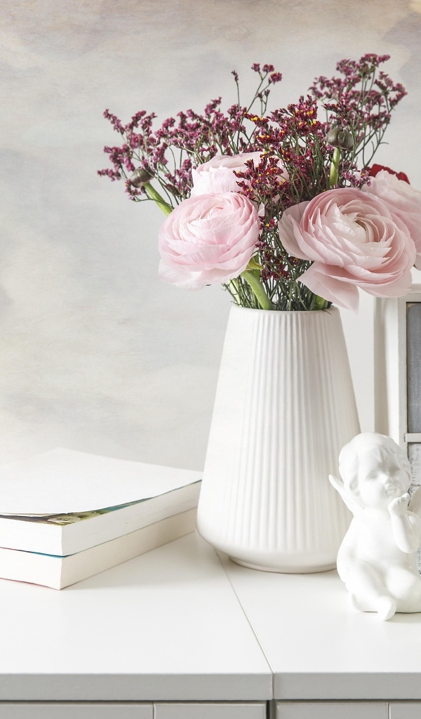 Букет розовых лютиков в вазе на столе