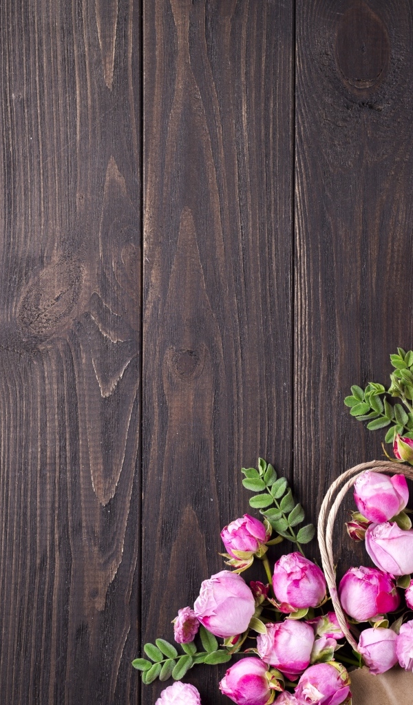 Бутоны розовой розы на деревянном столе