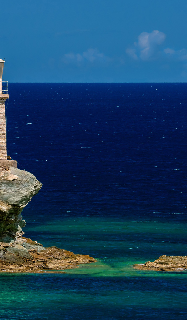 Старый маяк на каменном острове в море