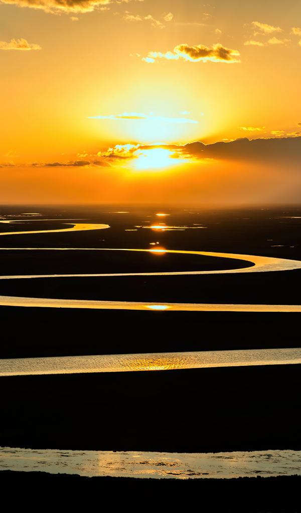 Извилистая река в лучах солнца на закате