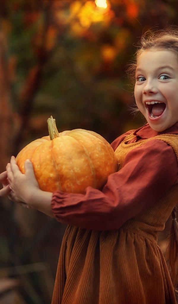 Маленькая рыжеволосая девочка с тыквой