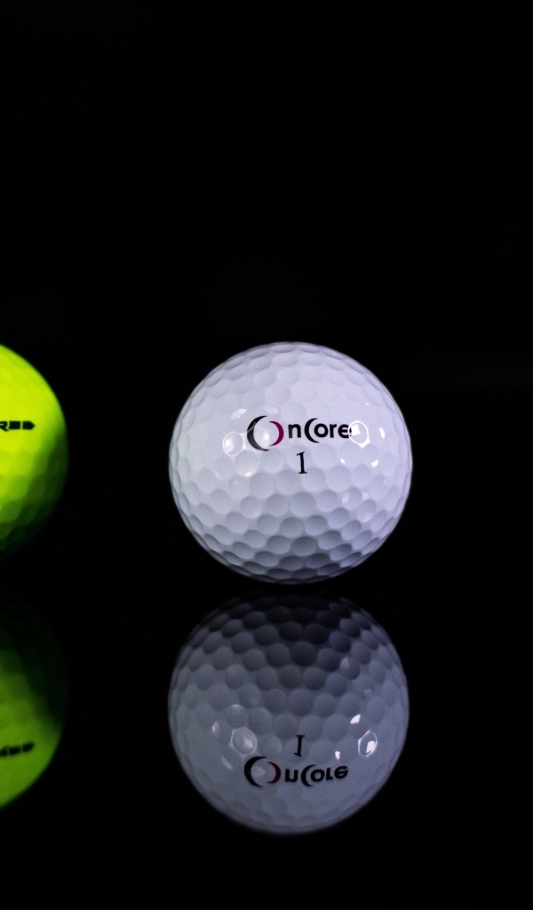 Два мяча для гольфа на черном фоне