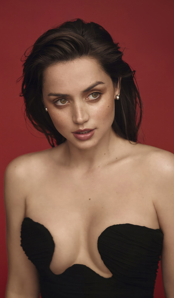 Актриса Ана де Армас в платье на красном фоне