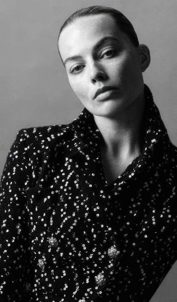 Грустная Марго Робби в блестящем пиджаке на сером фоне