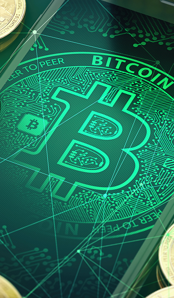 Золотые монеты биткоин со смартфоном на столе