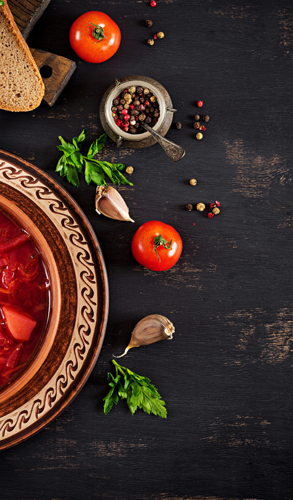 Вкусный красный борщ в тарелке на столе