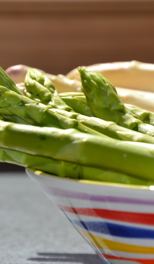 Зеленая спаржа в тарелке на столе