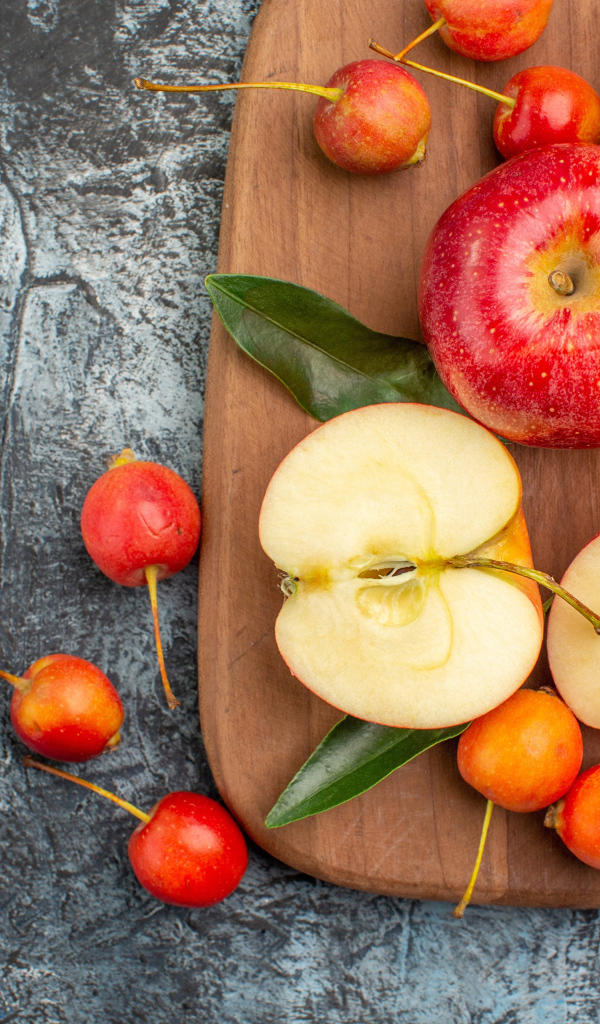 Нарезанные яблоки на деревянной доске на столе