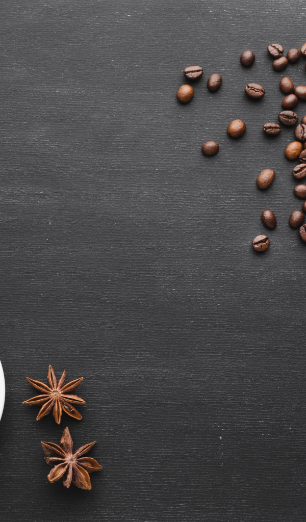 Чашка кофе на черном столе с зернами