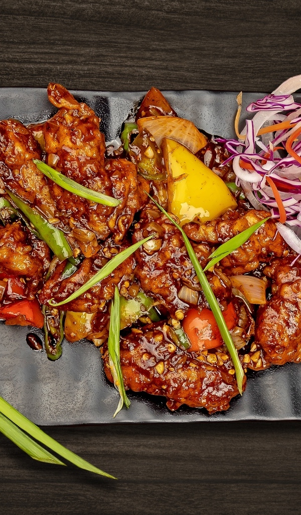 Острые куриные крылышки с салатом на тарелке