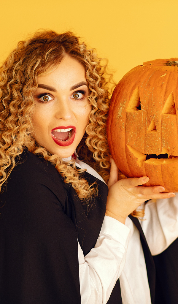 Удивленная девушка с тыквой на Хэллоуин