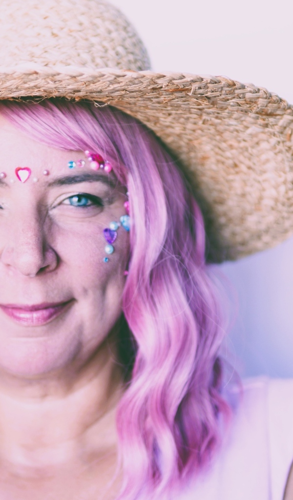 Женщина в шляпе с розовыми волосами