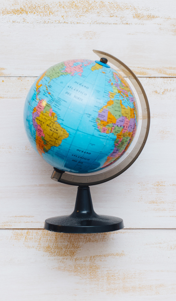 Глобус на деревянном фоне с канцелярскими предметами