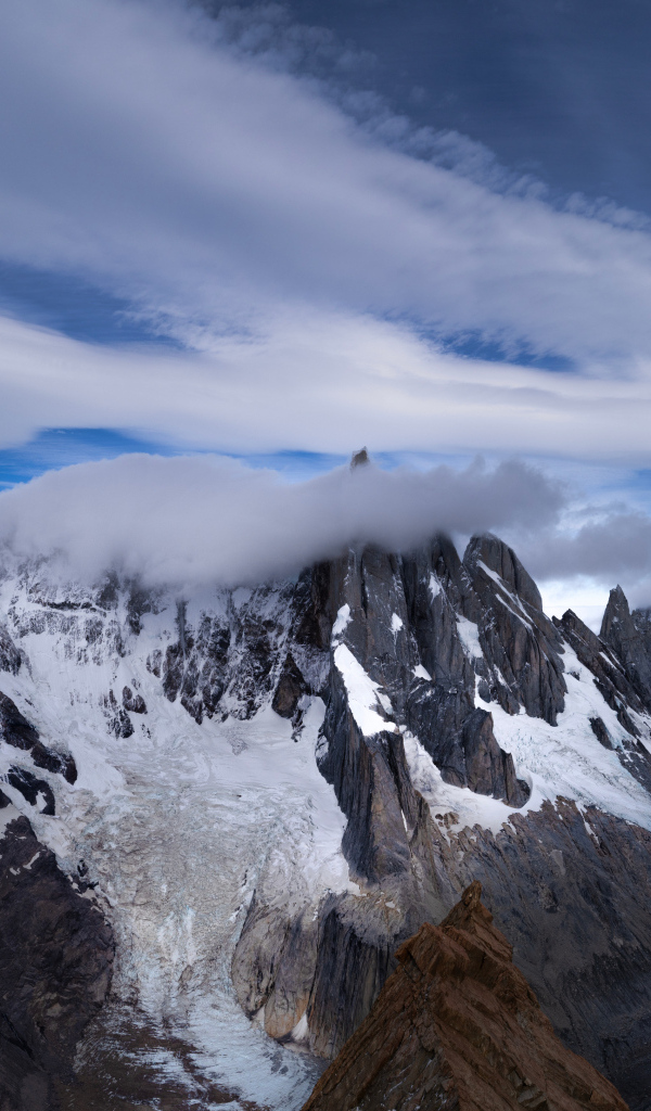 Белые облака над холодными заснеженными горами
