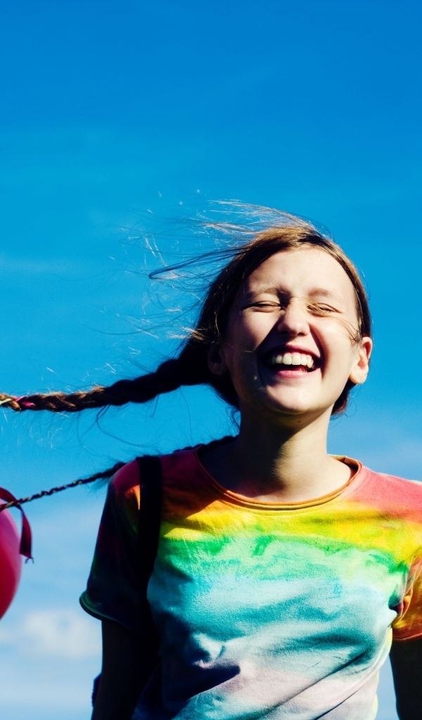 У веселой девочки шарики привязаны к косам