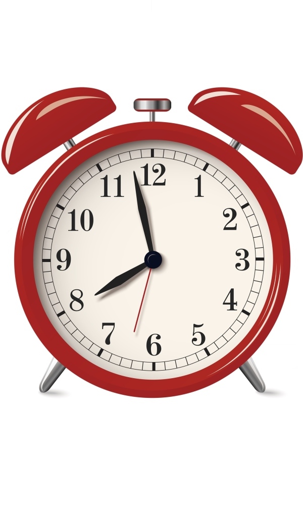 Красный будильник на белом фоне