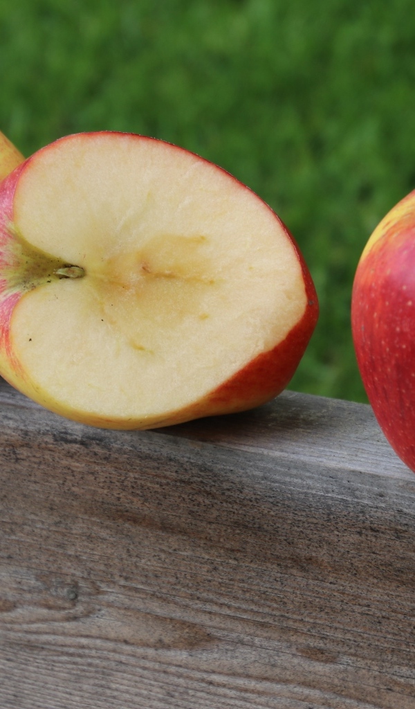 Красные яблоки лежат на деревянной доске
