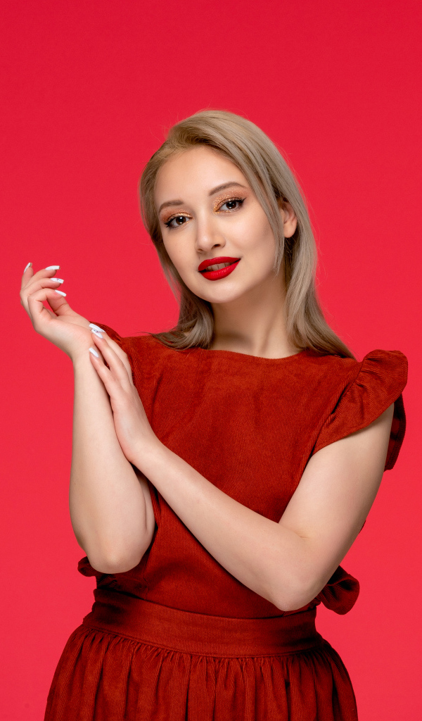 Красивая девушка в красном платье на красном фоне